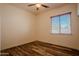 Bedroom featuring hard wood floors, ceiling fan, and a window bringing in natural light at 4702 N 151St Dr, Goodyear, AZ 85395