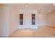 Bright entryway with neutral walls, tiled floor, and a door flanked by windows with privacy blinds at 4702 N 151St Dr, Goodyear, AZ 85395