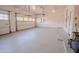 Wide view of the epoxy-floored three-car garage, showcasing ample space and convenient access to the interior at 4702 N 151St Dr, Goodyear, AZ 85395