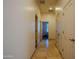 Hallway with tile floors and access to rooms at 4702 N 151St Dr, Goodyear, AZ 85395