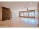 Spacious living room featuring stone accent walls and lots of natural light from large windows at 4702 N 151St Dr, Goodyear, AZ 85395