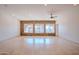 Open living room featuring tile flooring, recessed lighting, and a stone wall of windows overlooking the backyard at 4702 N 151St Dr, Goodyear, AZ 85395