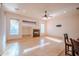 Bright living room with tile flooring, fireplace, ceiling fan, and lots of natural light at 4702 N 151St Dr, Goodyear, AZ 85395