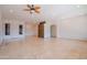 Spacious living room featuring tile flooring, recessed lighting, and a stone accent wall dividing the room at 4702 N 151St Dr, Goodyear, AZ 85395