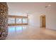 Spacious living room featuring stone accent walls, tile flooring, recessed lighting, and an open floor plan at 4702 N 151St Dr, Goodyear, AZ 85395