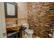 Unique powder room featuring a decorative sink and an eye-catching stone wall at 4702 N 151St Dr, Goodyear, AZ 85395