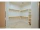 Walk-in closet with built-in shelving and rods, offering ample storage space at 4702 N 151St Dr, Goodyear, AZ 85395