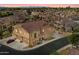 Stunning aerial view of a luxurious home showcasing its tile roof, stone accents, and three-car garage at 4777 S Fulton Ranch Blvd # 1098, Chandler, AZ 85248