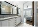 Bathroom with double sinks, a large mirror, and a view into the bedroom at 4777 S Fulton Ranch Blvd # 1098, Chandler, AZ 85248