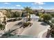 Community entrance featuring a private gate, lush landscaping, and a decorative stone sign at 4777 S Fulton Ranch Blvd # 1098, Chandler, AZ 85248