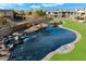 Scenic view of the community pond with waterfall feature, lush landscaping, and inviting walking paths at 4777 S Fulton Ranch Blvd # 1098, Chandler, AZ 85248