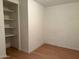 Bedroom with a white brick wall, wood floors and a built-in closet at 5000 W Osborn Rd, Phoenix, AZ 85031