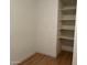 Small closet with hardwood floors and built in shelving at 5000 W Osborn Rd, Phoenix, AZ 85031