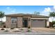 Charming single-story home featuring a brick facade, neutral color palette and attached two-car garage at 5961 S Stonecreek Blvd, Gilbert, AZ 85298