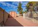 Backyard featuring a shed, a block wall, and a white metal fence at 6208 W Willow Ave, Glendale, AZ 85304