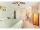 Neutral bedroom with a king bed, ceiling fan, carpet floors and ensuite bathroom access at 6208 W Willow Ave, Glendale, AZ 85304