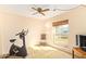 Cozy bedroom featuring a window with blinds and an exercise bike at 6208 W Willow Ave, Glendale, AZ 85304