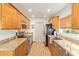 Galley kitchen with granite countertops, stainless steel appliances, and wood floors at 6208 W Willow Ave, Glendale, AZ 85304