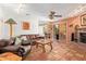 Cozy living room featuring Saltillo tile floors, a brick fireplace, leather furniture and rustic decor at 6208 W Willow Ave, Glendale, AZ 85304