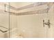 Modern tiled shower with glass door and decorative tile accents at 6208 W Willow Ave, Glendale, AZ 85304