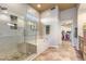 Bathroom with a glass enclosed shower, soaking tub, and walk-in closet at 6998 E Soaring Eagle Way, Scottsdale, AZ 85266