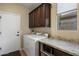 Functional laundry room with granite countertops, modern appliances, and ample storage at 6998 E Soaring Eagle Way, Scottsdale, AZ 85266