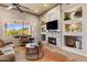 Inviting living room with a stone fireplace, built-in shelving, and comfortable seating at 6998 E Soaring Eagle Way, Scottsdale, AZ 85266