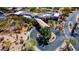 Aerial view of the clubhouse with porte cochere and a circular driveway entrance, surrounded by desert landscape at 7016 E Stone Raven Trl, Scottsdale, AZ 85266