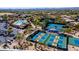 Wide aerial view of community featuring multiple pickleball courts, a pool, clubhouse and parking at 7016 E Stone Raven Trl, Scottsdale, AZ 85266