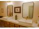 Elegant bathroom featuring dual sinks with gold fixtures and modern lighting at 7016 E Stone Raven Trl, Scottsdale, AZ 85266