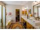 Luxurious bathroom featuring double sinks, a soaking tub, and a walk-in closet at 7016 E Stone Raven Trl, Scottsdale, AZ 85266