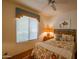 Cozy bedroom with floral bedding, a ceiling fan, and natural light from a window at 7016 E Stone Raven Trl, Scottsdale, AZ 85266