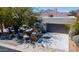 View of charming desert home featuring barrel cactus, desert landscaping, and an attached two-car garage at 7016 E Stone Raven Trl, Scottsdale, AZ 85266