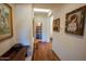 Inviting hallway with hardwood floors and decorative artwork at 7016 E Stone Raven Trl, Scottsdale, AZ 85266