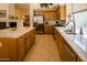 Spacious kitchen featuring granite countertops, stainless steel appliances, and wooden cabinets at 7016 E Stone Raven Trl, Scottsdale, AZ 85266