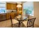 Bright breakfast nook with a glass table, chairs, and window views at 7016 E Stone Raven Trl, Scottsdale, AZ 85266