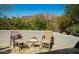 Relaxing patio area with lounge chairs, beautiful greenery, and scenic mountain views at 7016 E Stone Raven Trl, Scottsdale, AZ 85266