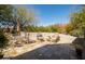 Charming patio with a dining set, lounge chairs, and views of the surrounding mountain scenery at 7016 E Stone Raven Trl, Scottsdale, AZ 85266