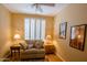 Bright sitting room features plantation shutters, side tables, and comfortable furnishings at 7016 E Stone Raven Trl, Scottsdale, AZ 85266