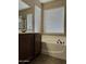 Bathroom featuring a soaking tub with tile flooring and a dark wood vanity at 7253 E Nathan St, Mesa, AZ 85207