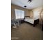 Comfortable bedroom with baseball themed wall and a cozy rocking chair at 7253 E Nathan St, Mesa, AZ 85207