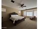 Spacious bedroom with natural light, a decorative bed frame and seating area at 7253 E Nathan St, Mesa, AZ 85207