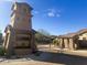 Community entrance with stone tower and gate, providing a secure and welcoming entry at 7253 E Nathan St, Mesa, AZ 85207