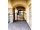 Arched entry with decorative iron gate and brick paved walkway at 7253 E Nathan St, Mesa, AZ 85207