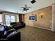 Comfortable living room featuring tile flooring, ceiling fan, and media center at 7253 E Nathan St, Mesa, AZ 85207