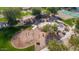 Aerial view of a community playground, featuring a variety of play structures and open space at 7253 E Nathan St, Mesa, AZ 85207