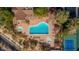 Aerial view of a community pool area with a large swimming pool and tennis courts at 7253 E Nathan St, Mesa, AZ 85207