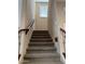 Carpeted staircase featuring a wrought iron banister, leading up to the next level of the home at 7253 E Nathan St, Mesa, AZ 85207