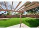 Backyard view from a covered patio and showcasing pristine artificial grass at 7259 W Tina Ln, Glendale, AZ 85310