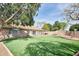 Backyard featuring a tile roof, patio, and pristine artificial grass at 7259 W Tina Ln, Glendale, AZ 85310